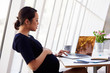 © Monkey Business - Pregnant Businesswoman Using Laptop In Office