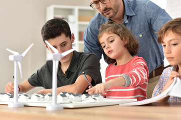 Wall Mural - Elementary school pupils learning about renewable energy