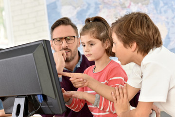 Wall Mural - Teacher with kids in computing class