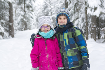 Little girl and boy in winter season