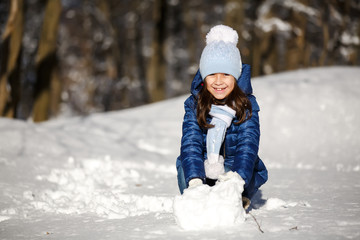 Little girl outdoors on beautiful winter snow day