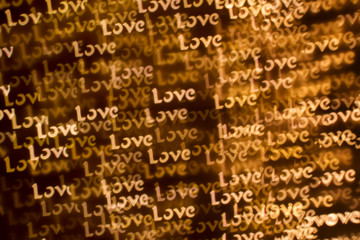 Wall Mural - Blurring lights bokeh background of words LOVE