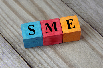 Wall Mural - SME text (Small Medium Enterprises) on colorful wooden cubes