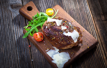 Beef steak on a wooden table.
