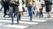 © milanares - Motion blurred pedestrians crossing sunlit street
