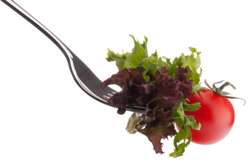 Fresh salad and cherry tomato on fork isolated on white backgrou