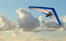 Hang Glider Flying In The Sky On Blue Day