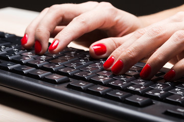 Woman typing on keyboard