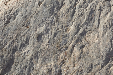 Natural rough stone texture background in sunlight