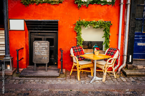 Vintage old fashioned cafe chairs with table in Copenhagen, Denmark Poster