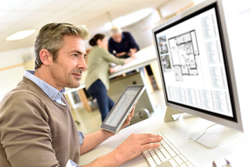 Engineer working in design office on desktop computer