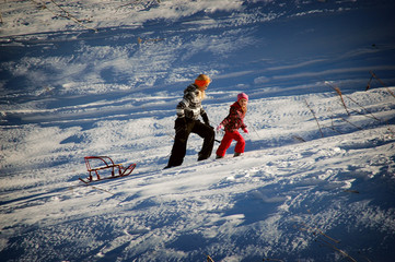 Young people traveling in Russia. Girl and woman trekkers on snow trail in forest.