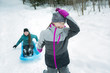 © Louis-Paul Photo - Children Pulling Sledge Through Snowy Landscape