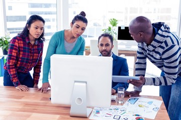 Wall Mural - High angle view of business people at desk