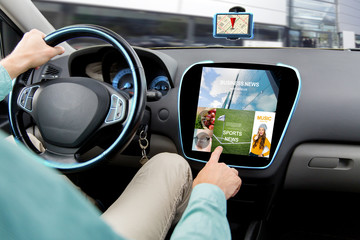 Canvas Print - close up of man driving car with news application