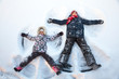 © Dmitry Naumov - Happy boy and girl  having fun together lying in a snow making snow angels