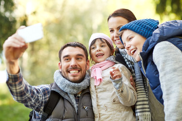 Poster - family taking selfie with smartphone outdoors