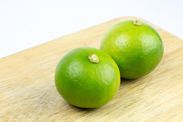 two limes on chopping block waiting to cut