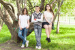 © svetlanafoto - Three happy friends boy and two girls walking in the park