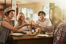In A Warm House, Two Couples Of Friends Having Fun During A Lunch 