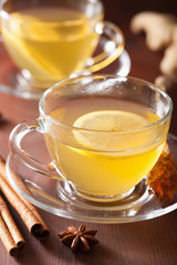 Wall Mural - hot lemon ginger cinnamon tea in glass cup