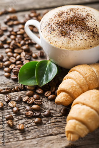 Nowoczesny obraz na płótnie Hot coffee and pastries on a wooden background