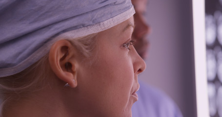 Wall Mural - Closeup of woman surgeon looking at xrays