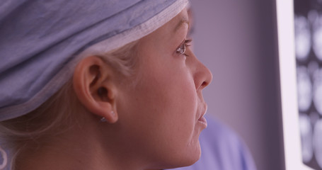 Wall Mural - Closeup of woman surgeon looking at xrays