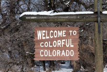 Wooden Welcome To Colorful Colorado Sign With Snow On Top