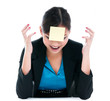 © iPortret - Frustrated businesswoman yelling with yellow post-it note on forehead