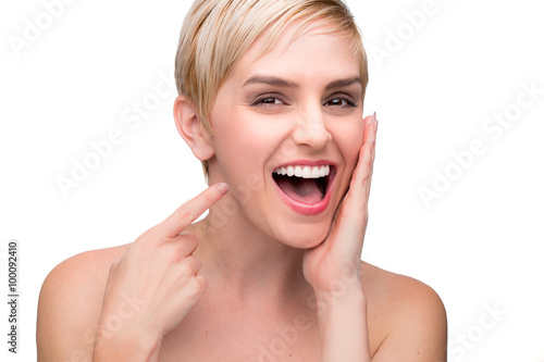 Fotografie, Obraz Cute fun laughing female with perfect white teeth straight smile pointing at mou