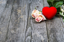 Beautiful Roses And Red Wax Heart On Old Wooden Board. Love Concept.