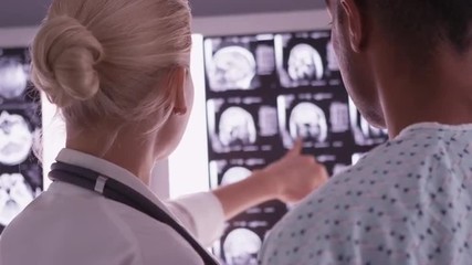 Wall Mural - Closeup of Woman doctor explaining xrays to patient