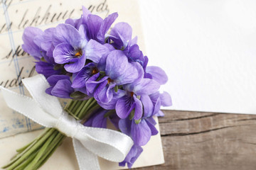bouquet of violet flowers (viola odorata) and vintage letters