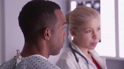 Wall Mural - Black patient listening to doctor explain test results