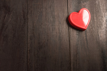 red heart pendant on a background of wood. Valentine's Day. Vale