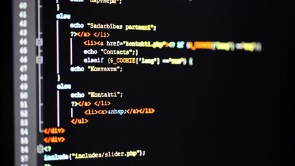 scrolling down the programming code on computer monitor
