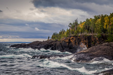 Lake Superior Coast, Gray Sky And Stormy Seas Crash On The Cliffs Of The Black Rocks Along The Shores Of The Lake Superior Coast. Presque Isle Park. Marquette, Michigan.