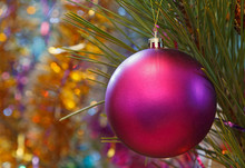 Close Up Of Purple Christmas Ball Ornament On Pine Tree
