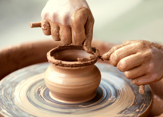 Hands working on pottery wheel