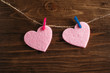 Pink hearts on wooden background.