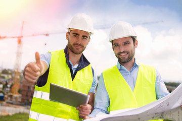 Wall Mural - Worker and architect watching some details on a construction