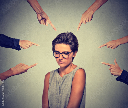 Cuadros en Lienzo Sad embarrassed woman in glasses looking down many fingers pointing at her