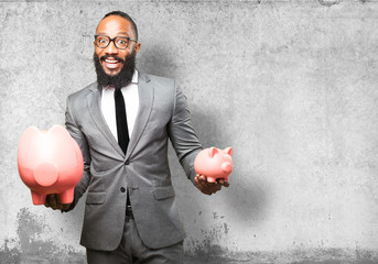 Wall Mural - business black man saving with a piggy bank