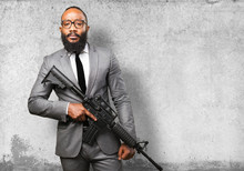 Business Black Man Holding A Machine Gun