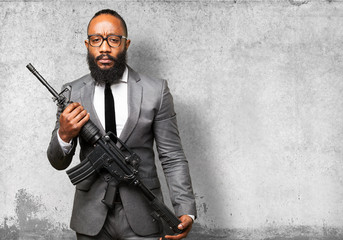 business black man holding a machine gun