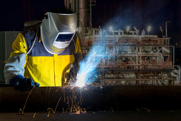 Worker with protective mask welding metal