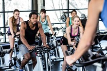 Fit People Working Out At Spinning Class