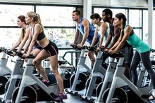 Fit People Working Out At Spinning Class