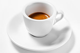 A cup of coffee on a plate isolated on white background. A cup of espresso . Focus on a cup